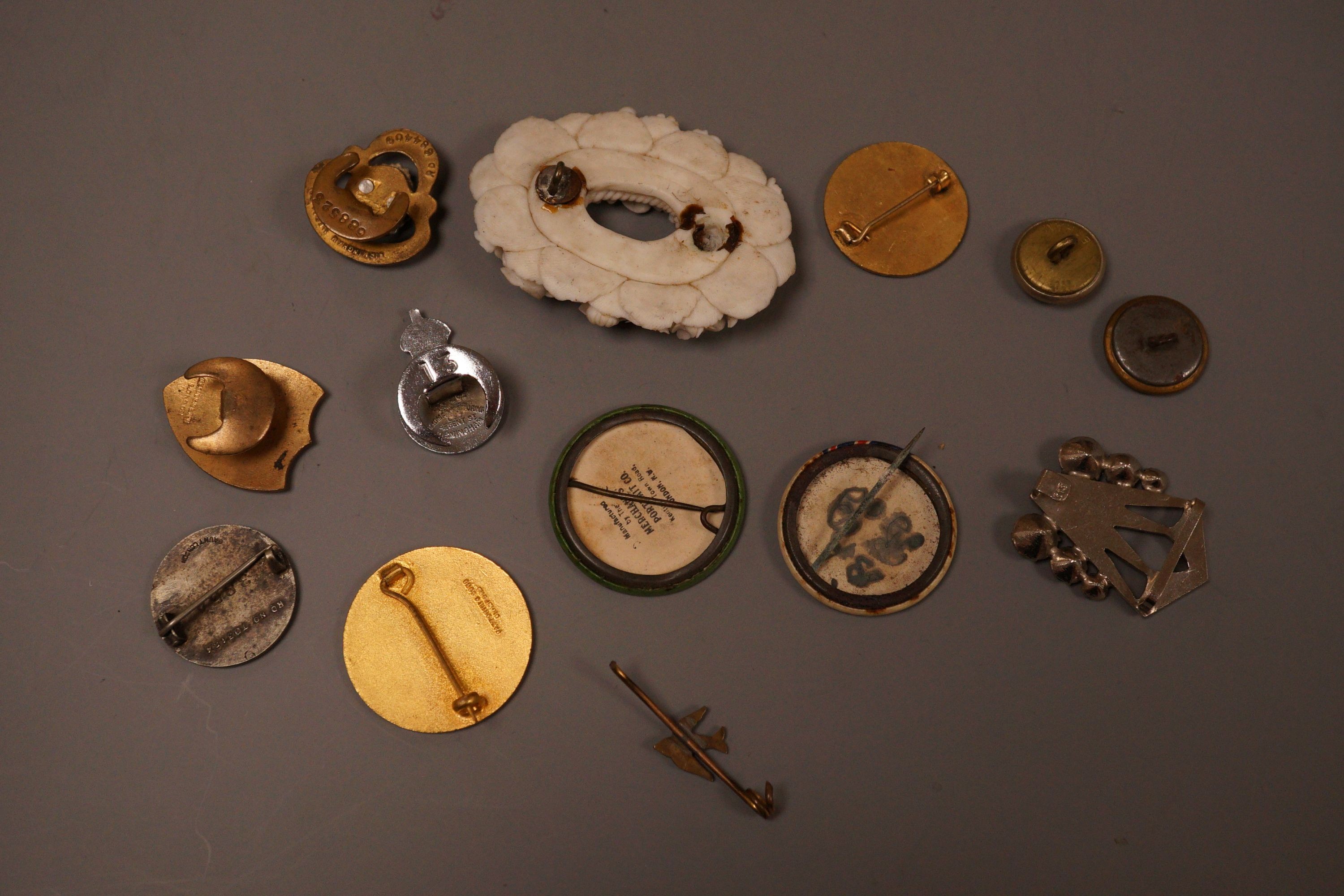A selection of badges, to include Suffragette Women's Social and Political Union ‘Votes For Women’, Eastbourne Association of Sussex Folk, and others